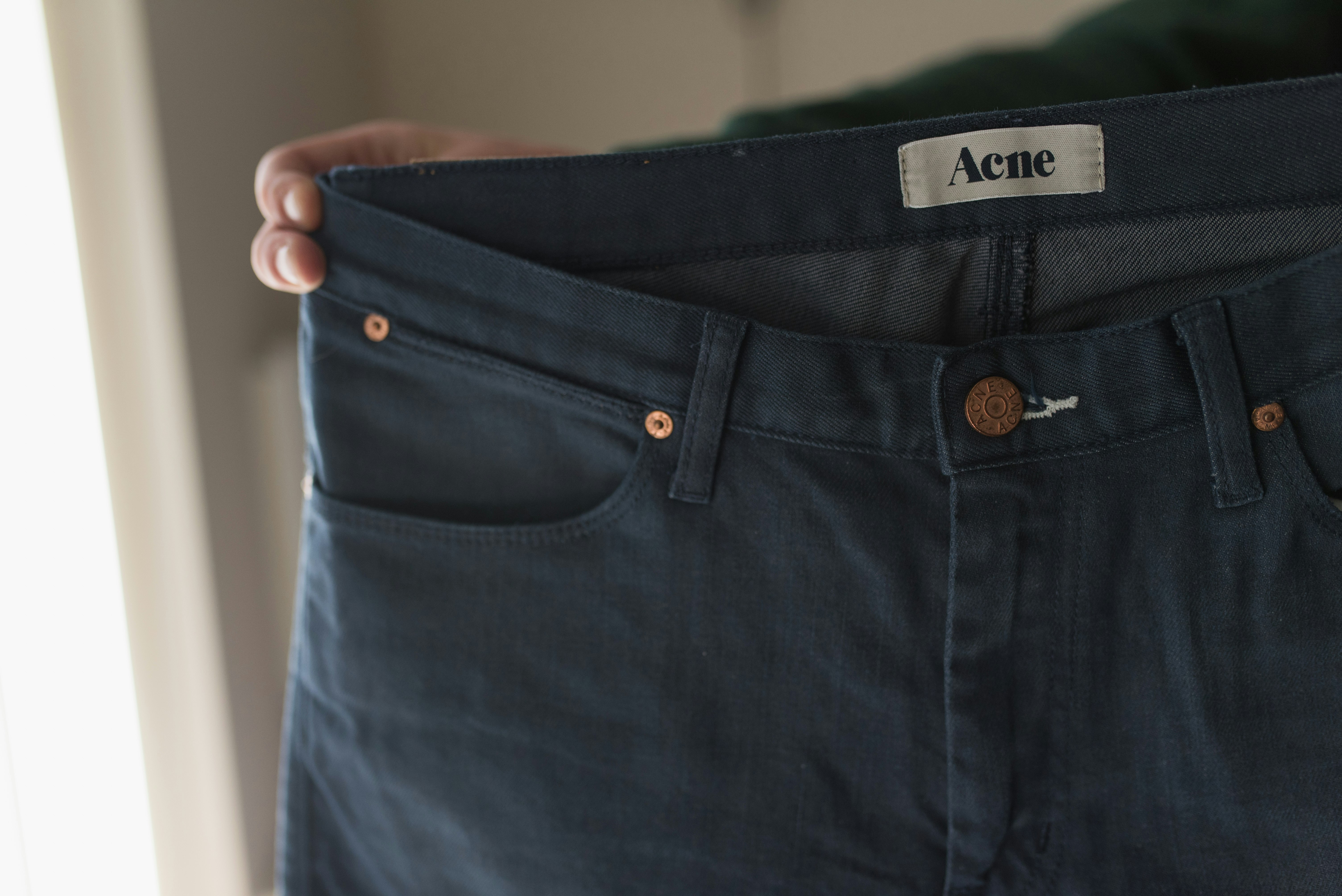 blue denim bottoms on white table